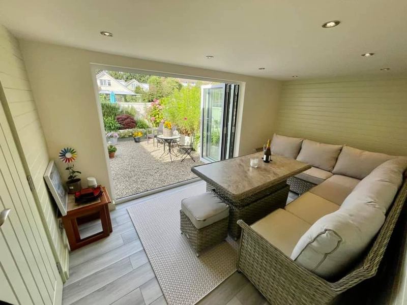 Converted garage in use as a living room, with bifold doors onto the garden